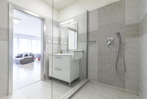 a bathroom with a shower and a sink at Greensgate Hotel Dýšina in Horomyslice
