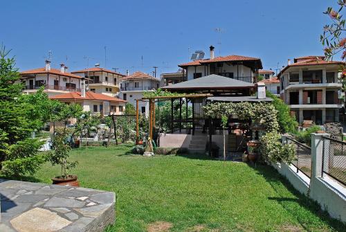 a garden with a gazebo in a city at Voula Kourbeti Apartments in Agios Nikolaos
