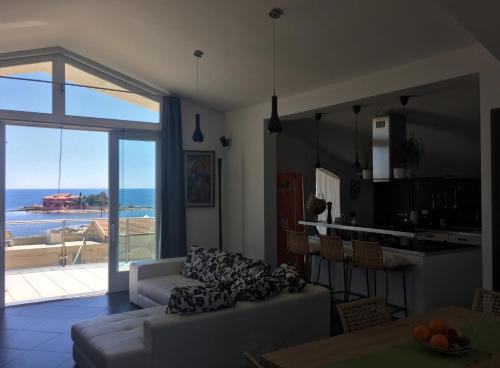 a living room with a couch and a view of the ocean at Casa Marea in Marzamemi