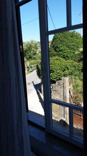 an open window with a view of a street at Nossa Casa na Aldeia in Viseu