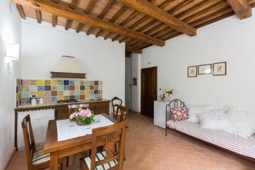 a kitchen and living room with a table and a couch at Il Borgo Di San Michele in Papigno