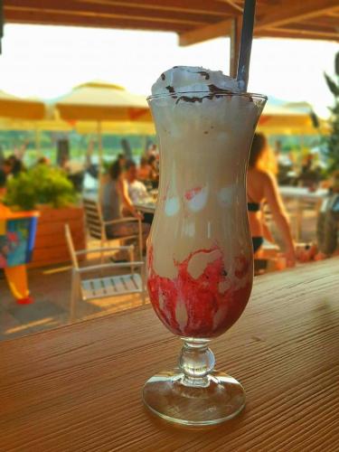 a drink in a glass sitting on a table at Green Resort Glamping in Radlje ob Dravi