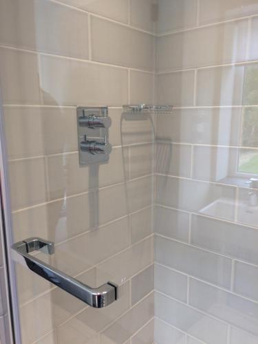 a bathroom with a shower with a glass door at The Garage in Banbury