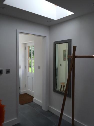 a hallway with a mirror and a skylight at The Garage in Banbury