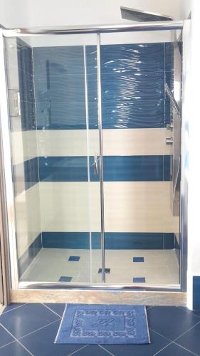 a shower with a glass door in a bathroom at Sogni Nel Blu in Ustica