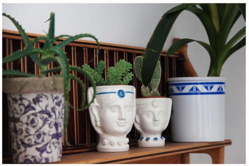 three blue and white vases sitting on a shelf with plants at Alvorada B&B in Palermo