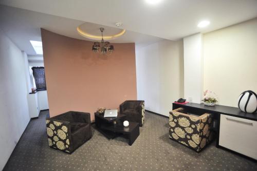 a meeting room with chairs and a table and a wall at B&B Rose in Vranje
