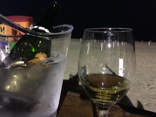 a glass of wine sitting next to a bucket of ice at Hotel Viking in Rimini