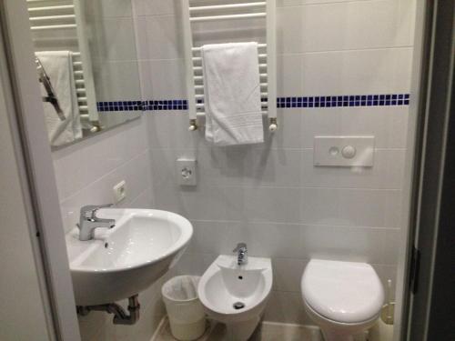 a bathroom with a sink and a toilet at Hotel Viking in Rimini