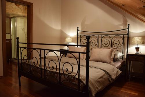 a bedroom with a black bed with two lamps at Chalet Caprea in Bad Kleinkirchheim