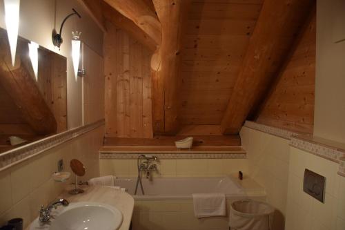 a bathroom with a sink and a bath tub at Chalet Caprea in Bad Kleinkirchheim