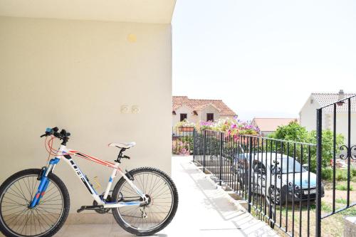 a bike is parked next to a fence at Apartments Panda in Bol