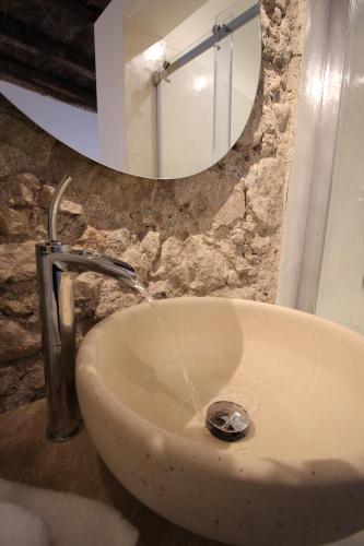 a sink with water running from a faucet in a bathroom at I Soffitti Dimora Esclusiva in Tropea