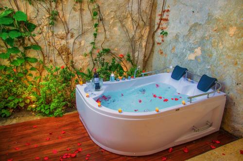 a bath tub filled with blue water on a deck at Casa Pizarro Hotel Boutique in Cartagena de Indias