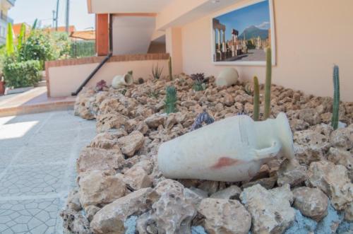 una bottiglia in un mucchio di rocce di fronte a una casa di B&B Villa Gaudium a Pompei