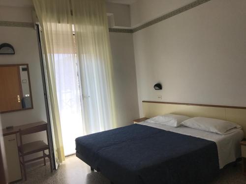 Postel nebo postele na pokoji v ubytování Hotel Luciana