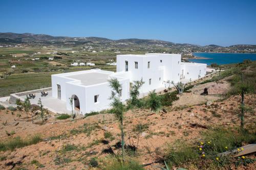 a white house on top of a hill at Natura Villas Paros in Molos Parou