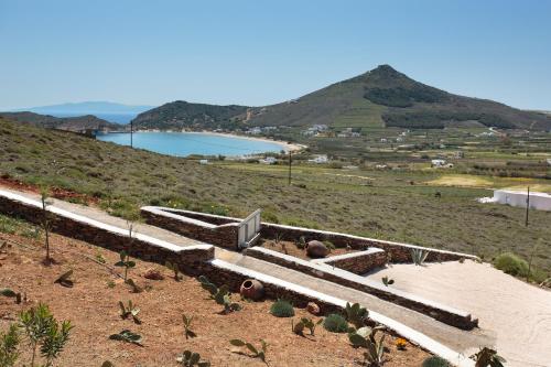 a view of a hill with a body of water at Natura Villas Paros in Molos Parou
