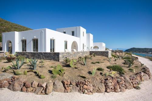 a white house with cacti in front of it at Natura Villas Paros in Molos Parou