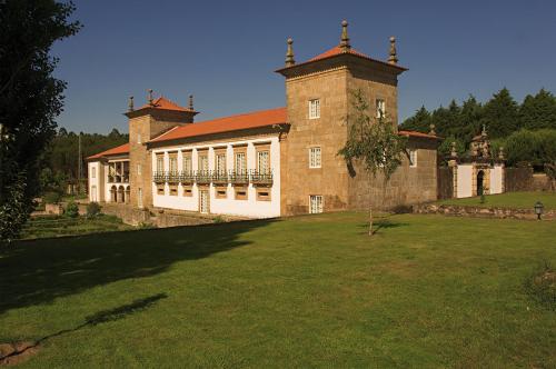 a large brick building with a large grass yard at Casa da Lage in Ponte de Lima