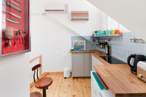 a kitchen with a table and chairs in a room at FeelingLisbon Tejo in Lisbon