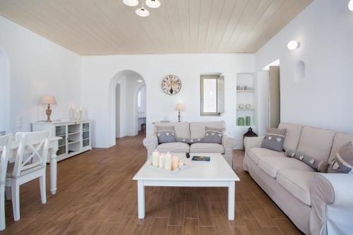 a living room with a couch and a table at Natura Villas Paros in Molos Parou