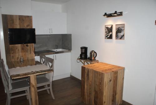 a kitchen with a counter and a table and a counter top at Champalo in Chamonix