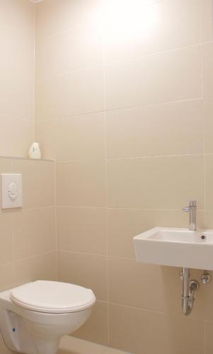 a bathroom with a toilet and a sink at Hauptbahnhof S2 in Vienna