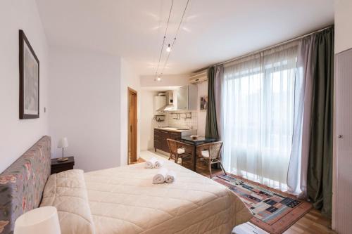 a living room with a large window and a couch at Prince Residence Apartments in Bucharest