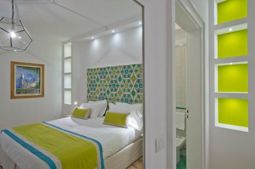 a white bedroom with a bed and a bathroom at Casa Stella Marina in Praiano