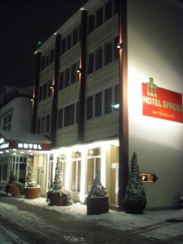 a hotel with christmas trees in front of a building at Hotel Sprenz in Oldenburg