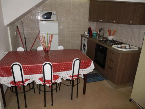 a kitchen with a red and white table and chairs at Casa Valente in Manfredonia