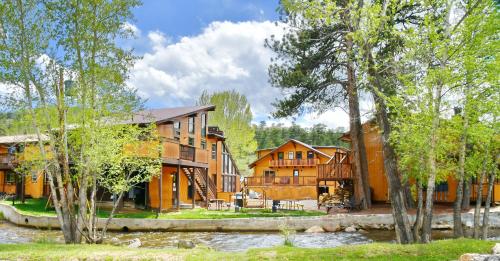 a large house with trees in front of it at Murphy's River Lodge in Estes Park