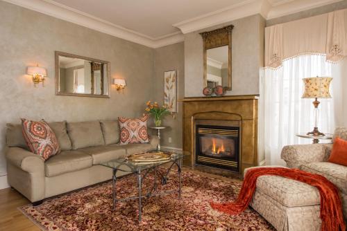 a living room with a couch and a fireplace at Captain Farris House in South Yarmouth