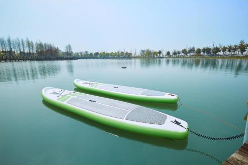 two kayaks tied to a dock on a lake at Fairmont Yangcheng Lake in Kunshan