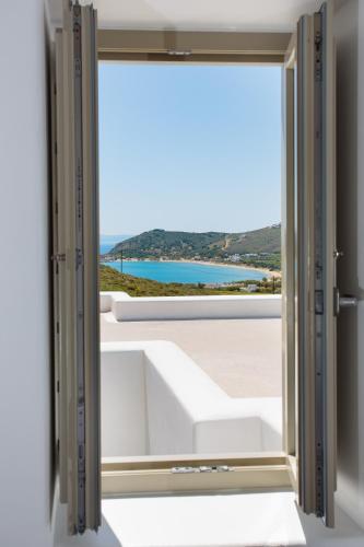 an open door to a window with a view at Natura Villas Paros in Molos Parou