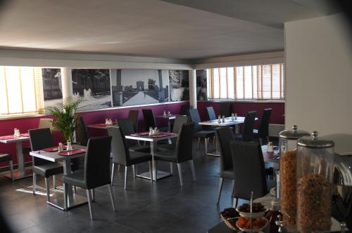 a restaurant with tables and chairs and purple walls at Privilège Hôtel & Apparts Eurociel Centre Comédie in Montpellier