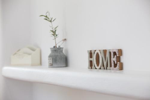 a shelf with the word love written on it at Natura Villas Paros in Molos Parou