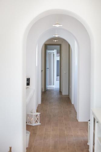 a hallway with white walls and a tile floor at Natura Villas Paros in Molos Parou