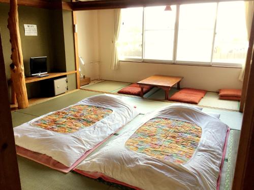 Ένα ή περισσότερα κρεβάτια σε δωμάτιο στο Village Sun Lake Kawaguchiko