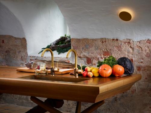 a kitchen sink with fruits and vegetables on a counter at Haraldskær Sinatur Hotel & Konference in Vejle