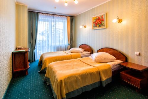 A bed or beds in a room at Stanislavsky Hotel Group