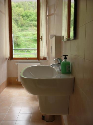 a bathroom with a sink and a window at Affittacamere B&B Trattoria della Posta in Maissana