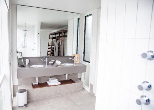 a bathroom with a sink and a large mirror at Lizard Island Resort in Lizard Island