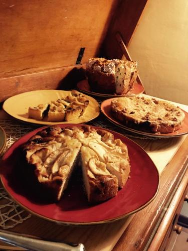 a table with three plates of pies on it at B&B La Dimora del Capitano in Fabriano