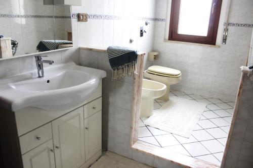 a bathroom with a sink and a toilet at Favignana Vacanze in Favignana