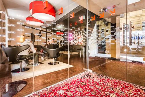 a hair salon with a red rug at Bohem Art Hotel in Budapest
