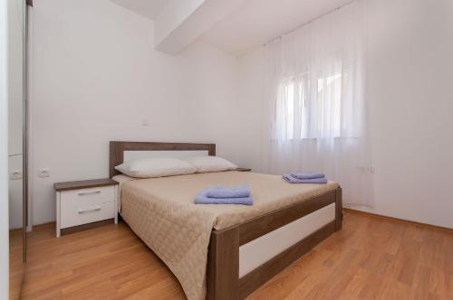 a bedroom with a bed with two towels on it at Apartman Mira- Omis in Omiš