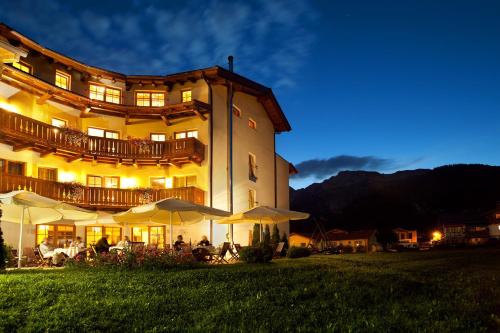 a large building with umbrellas in front of it at Hotel Saliter Hof in Saalfelden am Steinernen Meer
