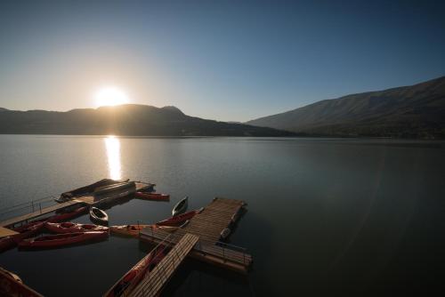 a group of canoes on a dock on a lake at Hotel Terradets in Cellers